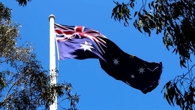 Close-up in low wind. 12 metre by six metre flag on a 45.7 metres high pole (or 150 feet in the old measure) –one foot for each year. Located at Picn
